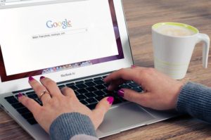 Photo of woman's hands typing on a laptop